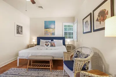 a bedroom with a bed and a chair in it at Hollywood Beach Bliss Villa Sleeps 10 in Hollywood