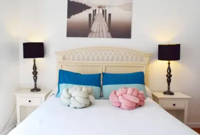 a bedroom with a bed with three pillows on it at Light-Filled Apt Steps to Beach Convention Center in Miami Beach