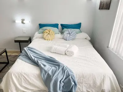 a large bed with towels and pillows on it at Right on the Beach Ocean Dr Secured Condo 206 in Miami Beach