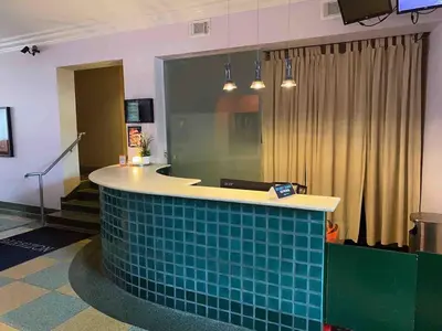 a lobby with a counter with blue tiles on it at Right on the Beach Ocean Dr Secured Condo 206 in Miami Beach