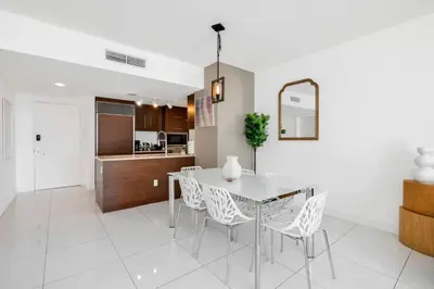 a kitchen and dining room with a table and chairs at W Hotel 2BR Ocean View, Pool, Spa, Free Gym Classes in Miami
