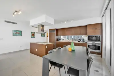 a kitchen with a table and chairs in a room at Wrap around Bay View, W Hotel Luxury 2BR 2BA, Pool, Spa, Free Gym Classes in Miami