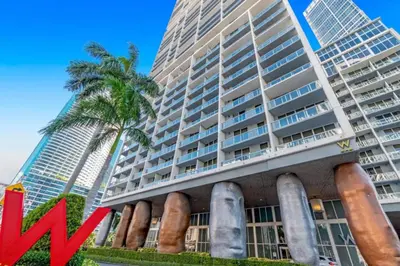 a large building in front of a tall building at Wrap around Bay View, W Hotel Luxury 2BR 2BA, Pool, Spa, Free Gym Classes in Miami