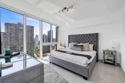 a bedroom with a large bed and large windows at Wrap around Bay View, W Hotel Luxury 2BR 2BA, Pool, Spa, Free Gym Classes in Miami