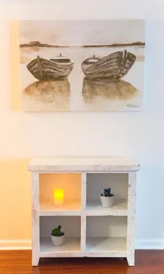 a white console table with two boats on a painting at Top Stay Miami Gold Brickell in Miami