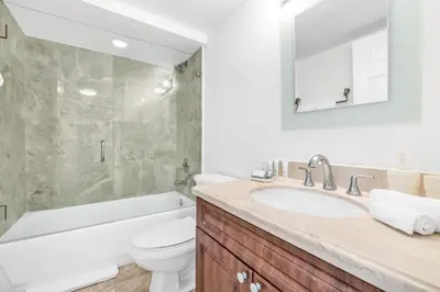 a bathroom with a sink and a tub and a toilet at Shine Suites Balcony Duplex 11 in Miami Beach