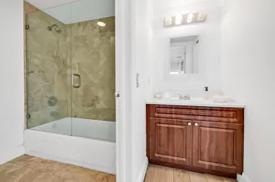 a bathroom with a tub and a sink and a shower at Shine Suites Balcony Duplex 11 in Miami Beach