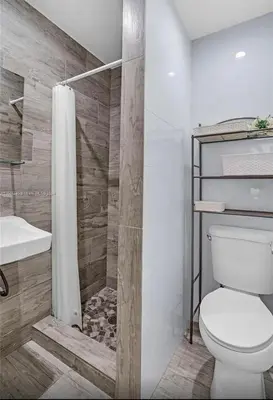 a bathroom with a toilet and a shower at Avocado House in Miami