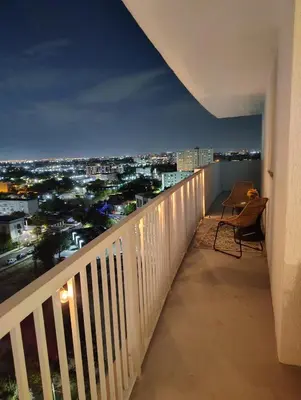 a balcony with a view of a city at night at 2Bedroom 2 Bath condo 10 Mins Walking To Jackson Memorial Hospital in Miami