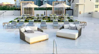 a patio with couches and tables and umbrellas at 2Bedroom 2 Bath condo 10 Mins Walking To Jackson Memorial Hospital in Miami