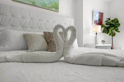 two towel swans are sitting on a bed at Icon Brickell Retreat 1BR and Spa, Pool, Views in Miami