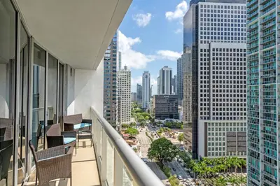 a balcony with chairs and a view of a city at Icon Brickell Retreat 1BR and Spa, Pool, Views in Miami