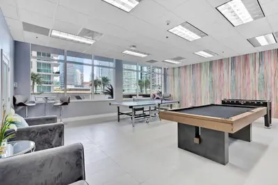 an office with a pool table and two tables at Skyline and Bay Glimpse 1BR Brickell Retreat in Miami