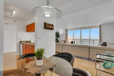 a kitchen and dining room with a table and chairs at Panoramic 2BR Bay-View in Brickell With Parking in Miami