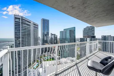a balcony with two chairs and a view of a city at Panoramic 2BR Bay-View in Brickell With Parking in Miami