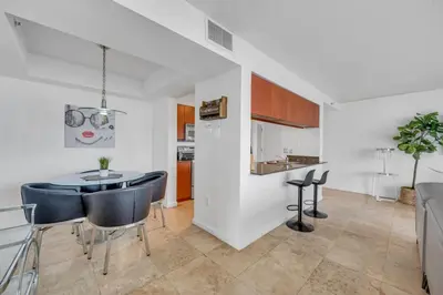 a kitchen and dining room with a table and chairs at Panoramic 2BR Bay-View in Brickell With Parking in Miami