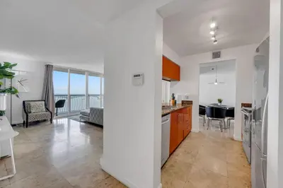 a kitchen and living room with a view of the ocean at Panoramic 2BR Bay-View in Brickell With Parking in Miami