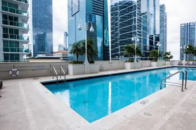 a swimming pool on the roof of a building with tall buildings at Bright and Cozy 2 Bedroom in Miami