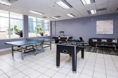 an office with two ping pong tables and a couch at Bright and Cozy 2 Bedroom in Miami