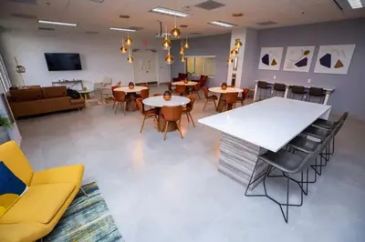 a large room with tables and chairs and a couch at Awesome 4BR APT at Brickell in Miami