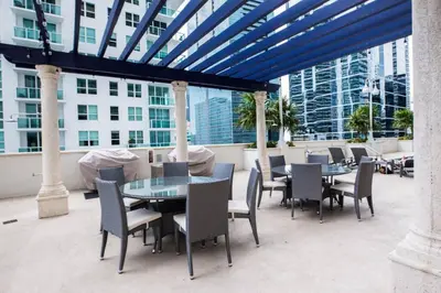 a patio with tables and chairs on a building at SPECTACULAR apt Brickell Miami FREE PARKING in Miami