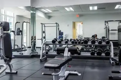 a gym with a lot of weights and machines at Lovely 2BR in the Heart of Brickell Free Parking in Miami