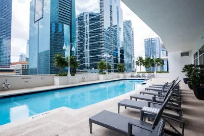 a swimming pool in a building with tall buildings at Lovely 2BR Rental in the Heart of Brickell in Miami