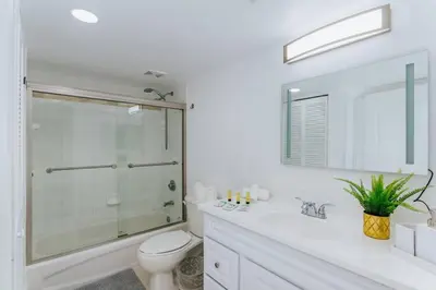 a white bathroom with a shower and a toilet at Amazing 2BR at Brickell Free Parking in Miami