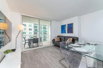 a living room with a glass table and a couch at 2bedroom ocean views brickell free parking in Miami