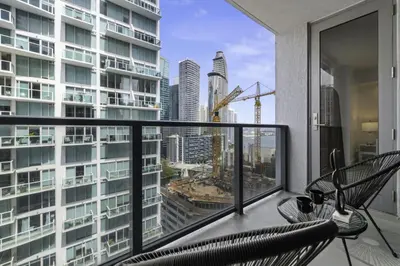 a balcony with a chair and a view of a city at Luxurious 2Bedroom Apt Parking in Brickell. in Miami