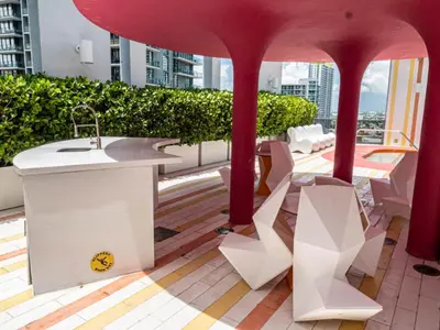 a balcony with a sink and chairs on a building at Luxurious 2Bedroom Apt Parking in Brickell. in Miami