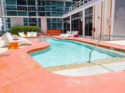 a large swimming pool with a slide in a building at Exclusive, Amazing, Bright and Spacious at Brickell in Miami