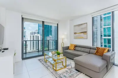 a living room with a couch and large windows at Exclusive, Amazing, Bright and Spacious at Brickell in Miami