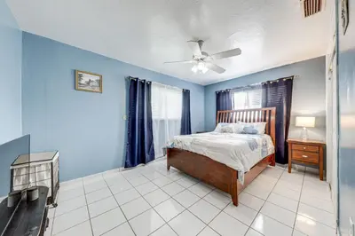 a bedroom with a bed and a ceiling fan at 4 Mi to Hard Rock Stadium Miramar Home with BBQ! in Miramar