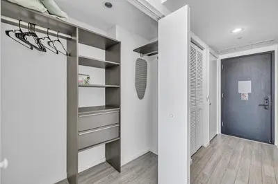 a hallway with white walls and a walk in closet at Sunset Waterview Oasis Studio in Miami