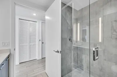 a bathroom with a shower with a glass door at Sunset Waterview Oasis Studio in Miami