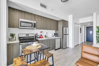 a kitchen with a stove and a table with chairs at Sunset Waterview Oasis Studio in Miami