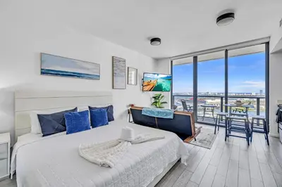 a bedroom with a bed and a view of the ocean at Sunset Waterview Oasis Studio in Miami