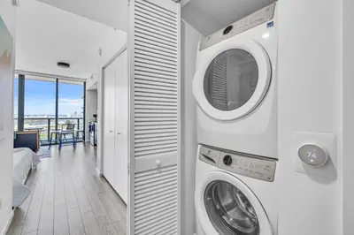 a laundry room with a washer and dryer at Sunset Waterview Oasis Studio in Miami