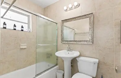 a bathroom with a sink toilet and a mirror at Spacious Home With King Bed Near Stadium in Norland