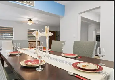 a dining room with a table with plates and glasses at Spacious Home With King Bed Near Stadium in Norland