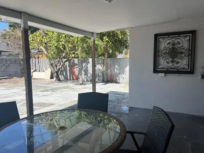 a glass table and chairs in a house at Coral Gable 3BR House in Miami
