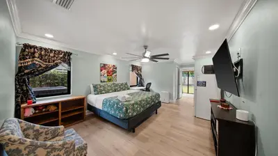 a bedroom with a bed and a flat screen tv at Private Entrance King Room and Private Bath UMiami in Miami