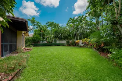 a yard with lush green grass and trees at Private Entrance King Room and Private Bath UMiami in Miami