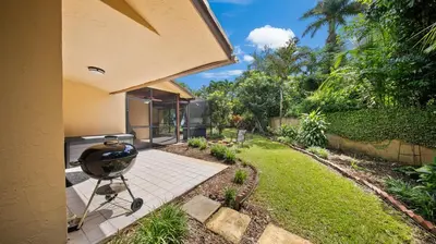 a backyard with a grill on a patio at Private Entrance King Room and Private Bath UMiami in Miami