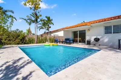 a swimming pool in the backyard of a house at 6BR 3BA Heated Pool Miami Vacation in Miami