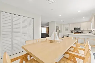 a kitchen and dining room with a wooden table and chairs at 6BR 3BA Heated Pool Miami Vacation in Miami