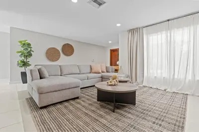 a living room with a couch and a table at 6BR 3BA Heated Pool Miami Vacation in Miami