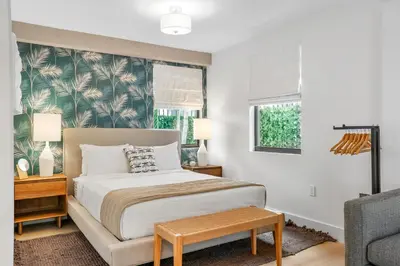 a bedroom with a bed and a couch and a chair at The Firefly in Miami Beach