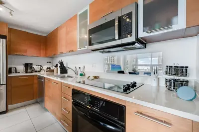 a kitchen with a sink and a stove at Midtown Muse -Walkable Cozy amenity bldg w parking in Miami